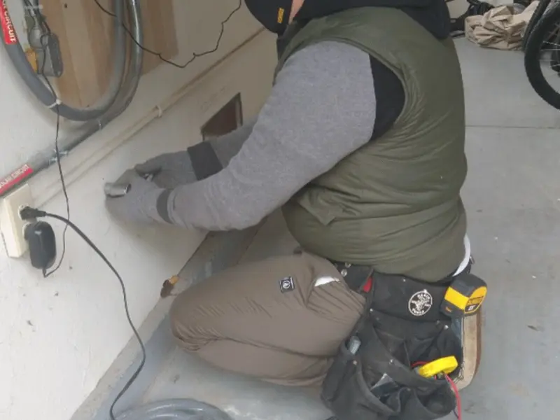 Electrician performing outlet wiring in a River Rouge garage